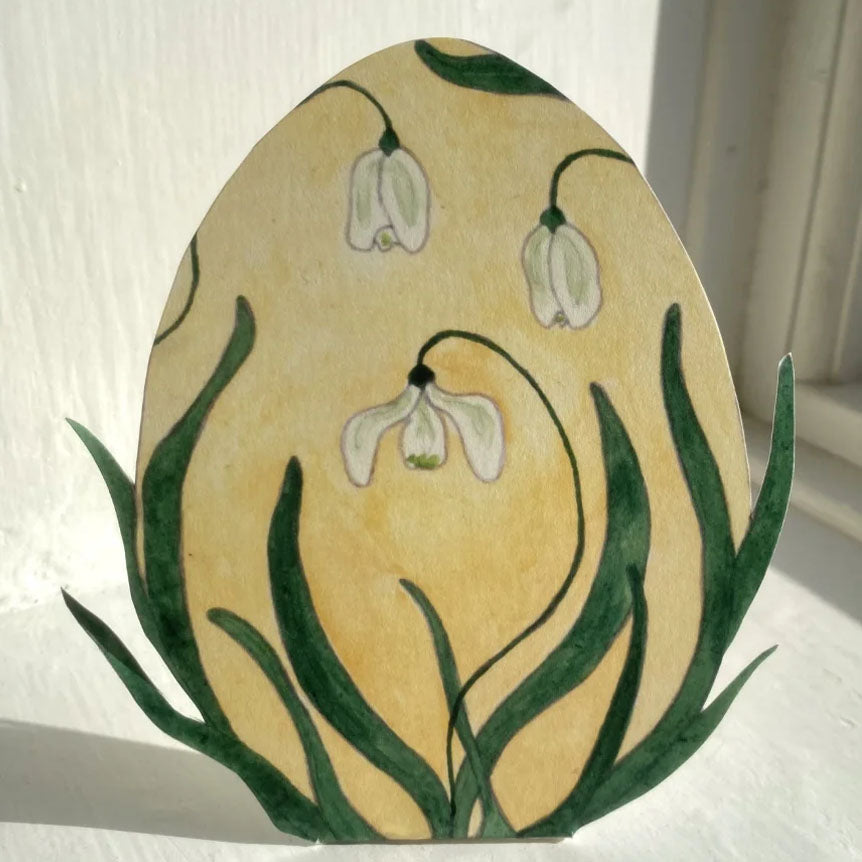 Snøklokke-egg med harer omkring