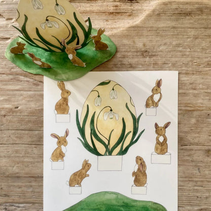 Snøklokke-egg med harer omkring